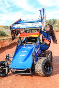Estela in front of car