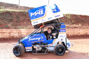 Estela smiling in car